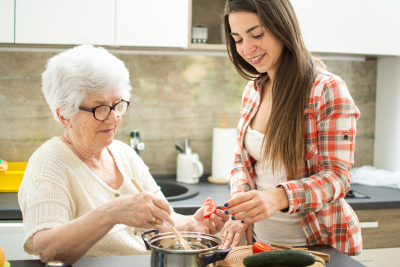 Grandmother with granddaughter cooking in the kitchen